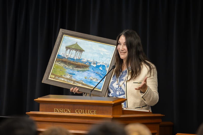 Sister Fabiana Alliaud shows one of her paintings to Ensign College students in Salt Lake City on Tuesday, Sept. 15, 2026.