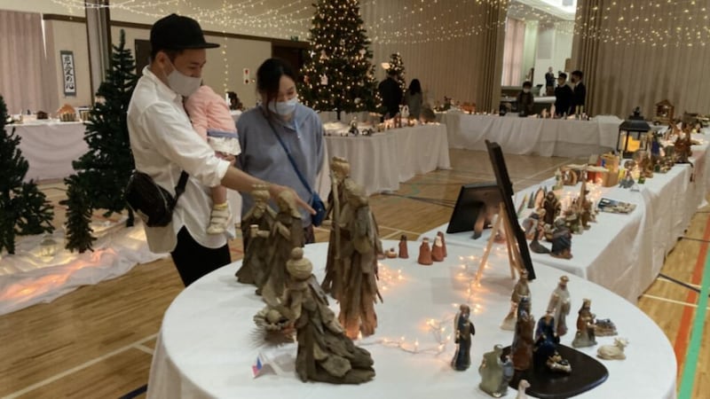 A family from Okinawa, Japan, enjoys a nativity and Christmas decoration display as Latter-day Saints open local meetinghouse doors to the community in mid-December 2020.