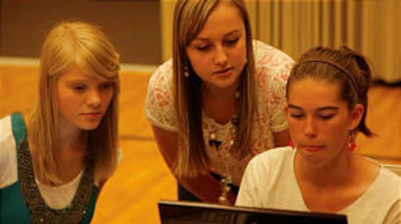 Mckayla Faddis (center) of the Dry Creek Ward helps Camille Muir, right, also of the Dry Creek Ward