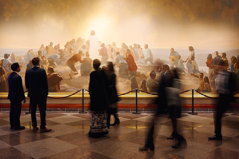 People walk past a painting of the Savior in the Conference Center in Salt Lake City prior to the Sunday morning session of the October 2025 general conference on Sunday, Oct. 5, 2025.