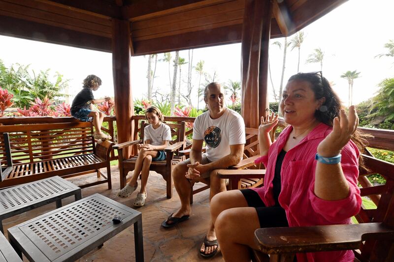 The Smith family sits in a gazebo on hotel grounds to talk about gratitude after the Maui wildfires in Lahaina, Hawaii.