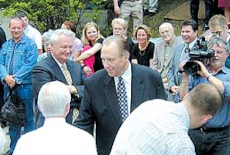 President Thomas S. Monson, followed by Elder Merrill J. Bateman, greets Maeser family and friends g