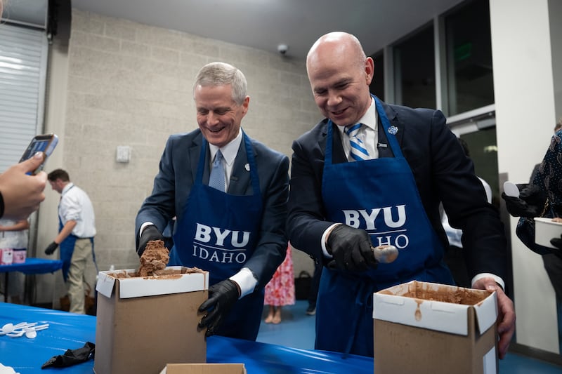 Elder David A. Bednar of the Quorum of the Twelve Apostles and BYU–Idaho President Alvin F. Meredith III help scoop ice cream for students following a devotional held in the I-Center in Rexburg, Idaho, on Thursday, Oct. 8, 2026.