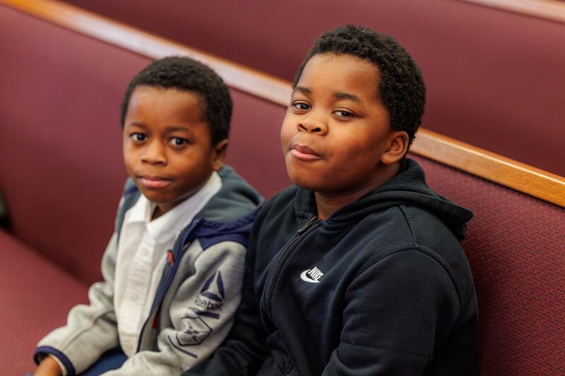 Two boys wait for church meetings to start in the new Treasure Valley Ward (Swahili) in Boise, Idaho, on Sunday, Feb. 8, 2026.