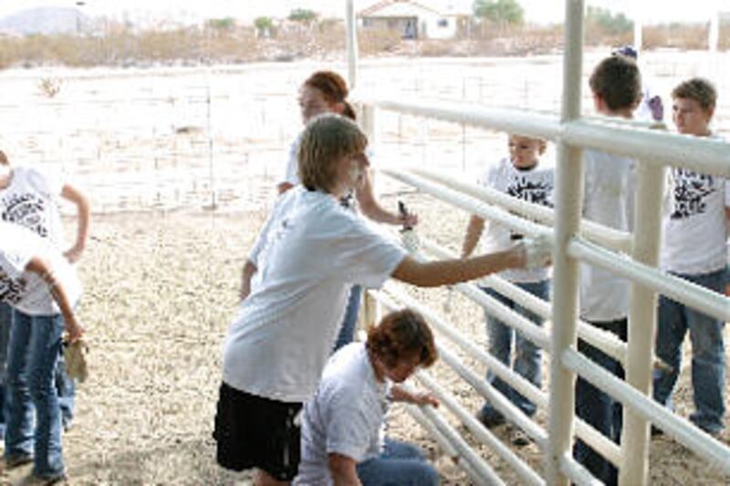 Chantel Adams of the Cullumber Ward paints by hand. Youth from the Gilbert Arizona Stake join youth