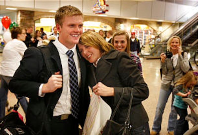 Elder Jake Hoj gets a hug from his mom, Shauna Hoj, upon returning home on Jan. 20 in the Salt Lake