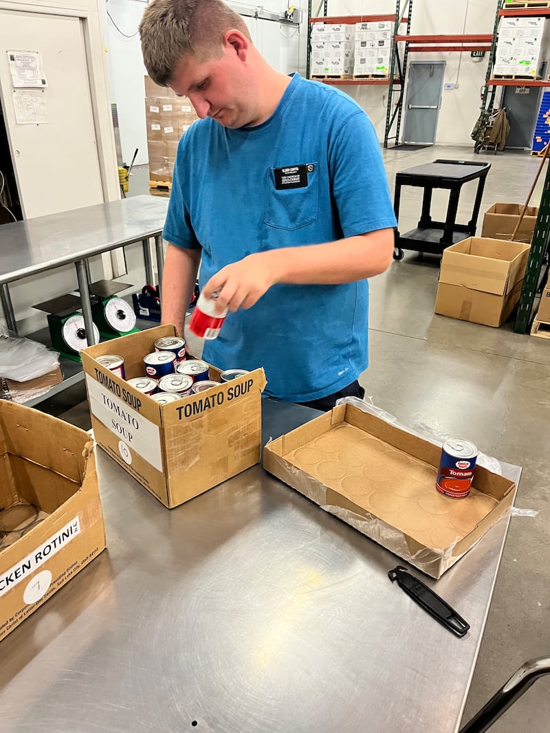 Elder Ashton Curtis, a service missionary in the Tucson Arizona East Stake, works at the bishops' storehouse in November 2025.