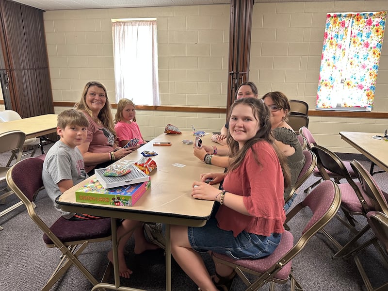 Pueblo Colorado Stake Young Women President Misty Koller plays a game with her family at the Pueblo Colorado Stake Center on July 10, 2026. The Koller family hosted a game room for the youth of Aspen Acres wildfire evacuees during a stake activity.