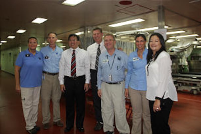 Mike Hughes, Elder Teh and Dr. John Jarstad together with their wives on board USNS Mercy.