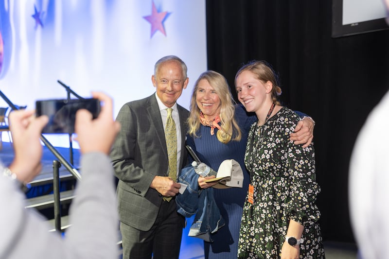 Elder Michael A. Dunn and his wife, Sister Linda P. Dunn pose with an attendee in Chandler, Arizona at the Deseret Days 2026 young single adult conference.