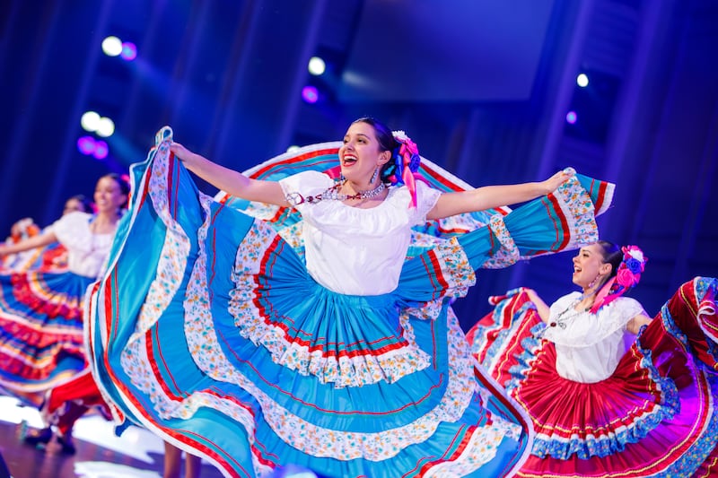 Dancers wearing traditional dress perform dances from across Latin America during a dress rehearsal of "Luz de las Naciones" in Salt Lake City, Utah, Nov. 3, 2025.