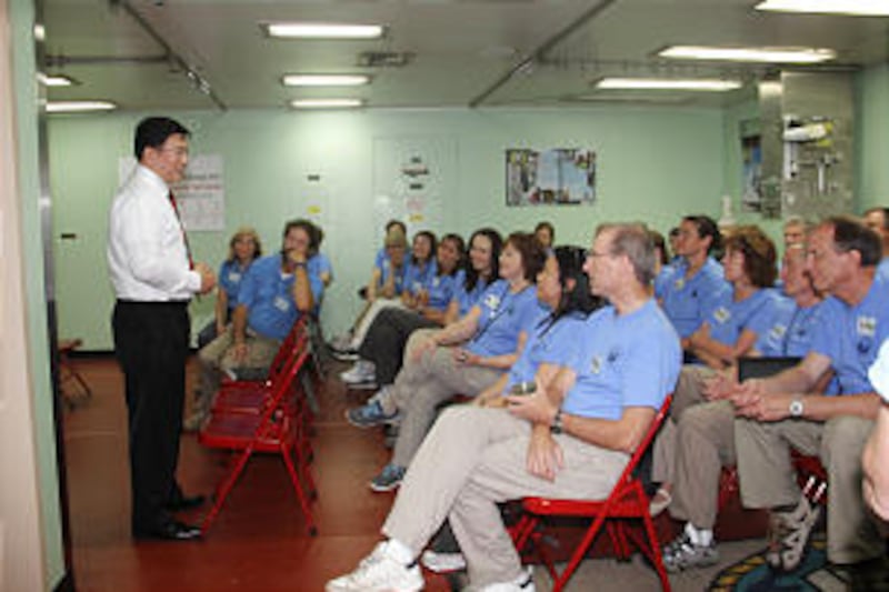 Elder Teh extends his thanks to the LDS Charities volunteers. Volunteers from the LDS Charities of