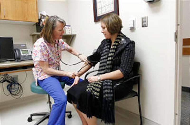 Registered nurse Jolynn Fleming checks the pulse rate of Sister Nadia Cectpa Burymski, from Southern