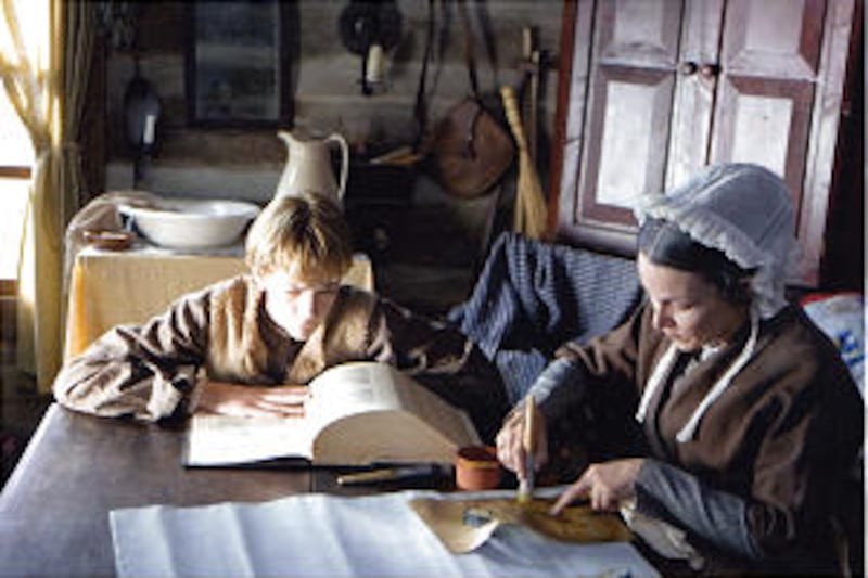 In scene from film, young Joseph Smith looks for answers in the Bible while his mother, Lucy Mack Sm