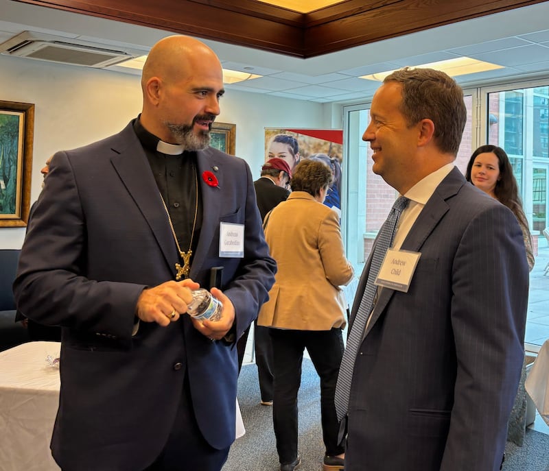 Two men speak at an interfaith gathering in Chicago, Illinois, Oct. 14, 2026.