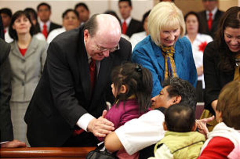 Elder Quentin L. Cook of the Quorum of the Twelve and his wife, Sister Mary Cook, greet members afte