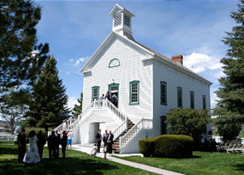 Members gather prior to dedicatory services May 15. The brilliantly white New England-style meetingh