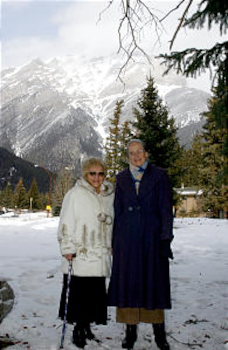 Behind the Banff meetinghouse with Cascade Mountain as a backdrop are recent branch converts Inez Pe