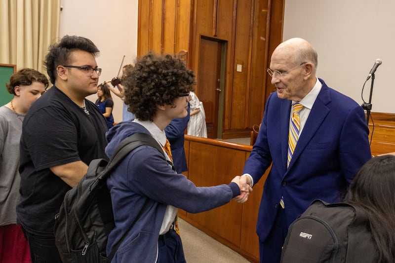 Elder Dale G. Renlund of the Quorum of the Twelve Apostles greets young adults after a devotional in Buenos Aires, Argentina, on Nov. 11, 2025.