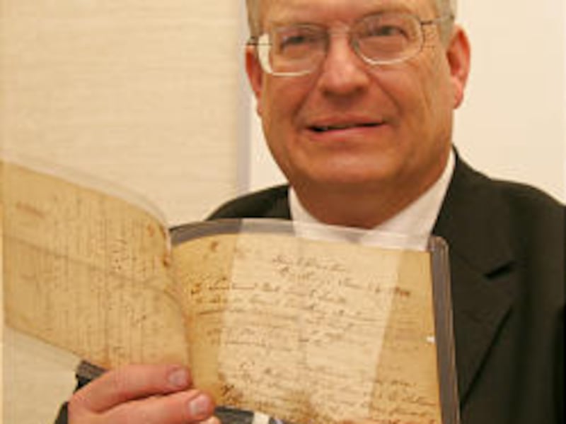 Brent Ashworth displays document originally saved by Wilford Woodruff.