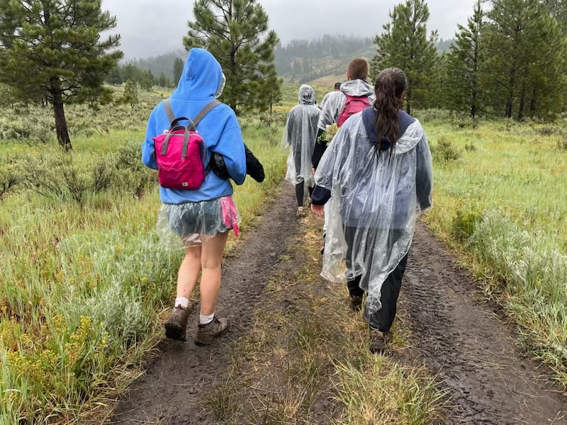 Youth of the Spokane Washington Valley Stake walk in the rain during Trek in Bend, Idaho on June 26, 2026.