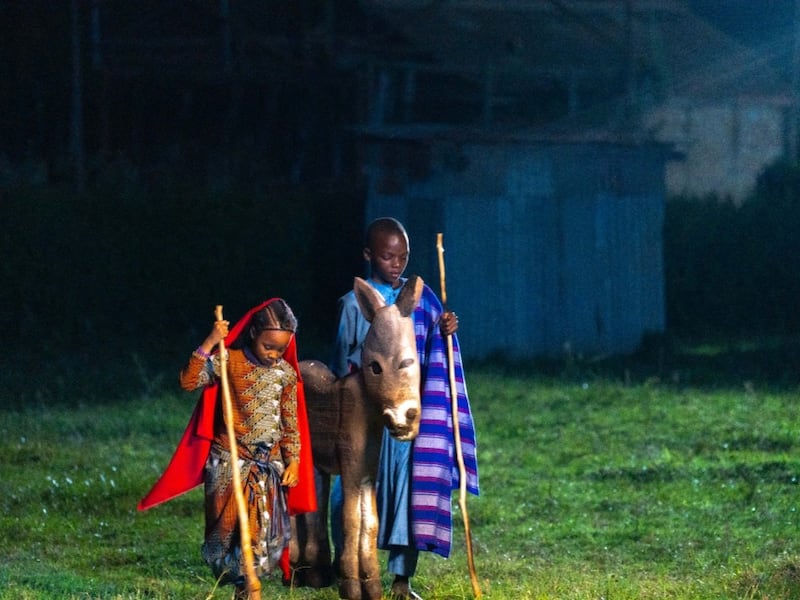 Children play the parts of Joseph and Mary with a donkey during filming of a Light the World video in Kenya in November 2025.