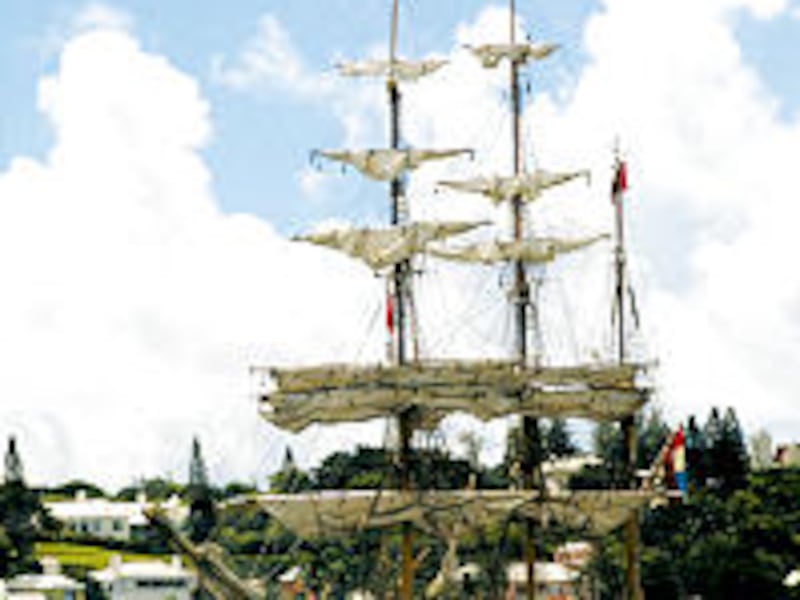 The ship <I>Europa</I>, with gray sail and gray hull, sits at anchor in Dundonald Channel off island