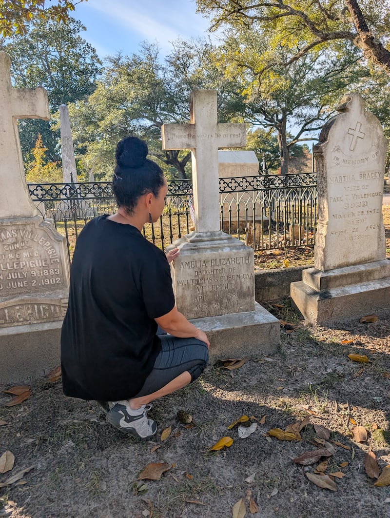 Vanessa Duerson looks at the head stone of one of her ancestors at Quaker Cemetery in Camden, South Carolina on Nov. 13, 2025.