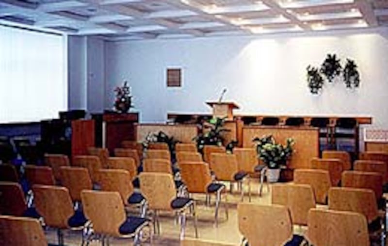 Interior of first-floor chapel of recently dedicated meetinghouse in Sofia; scores of people attende