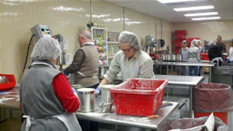 Will and Judith Perkins, members of the Brockett Ward, Atlanta Georgia Stake, work alongside a young