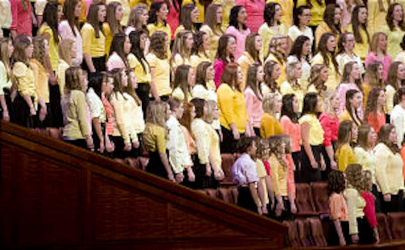 The choir sings during the meeting as thousands of young women attend general Young Women's meeting