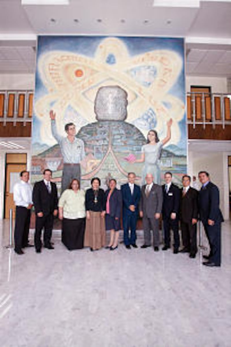 Benemerito, MTC and Mexico educational officials gather in front of an education-themed mural at the