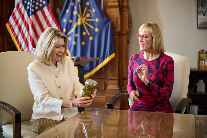 President Camille N. Johnson receives a jar of homemade pickled jalapenos from Indiana Lt. Gov. Suzanne Crouch.