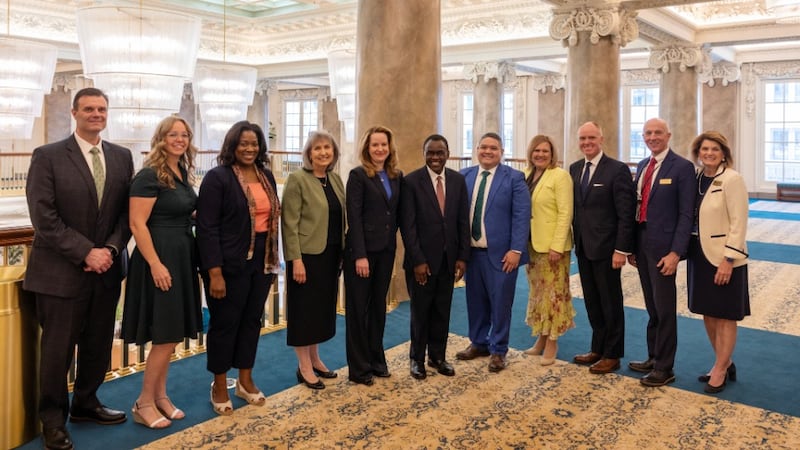International Organization for Migration Director General Amy Pope, center, and others from the organization pose with Elder Edward Dube of the Presidency of the Seventy, to Pope's left; Sister J. Anette Dennis of the Relief Society General Presidency, to Pope's right; and staff from the Church Communication and Welfare and Self-Reliance Services Departments. Pope visited Church headquarters in Salt Lake City on May 11-12, 2026.