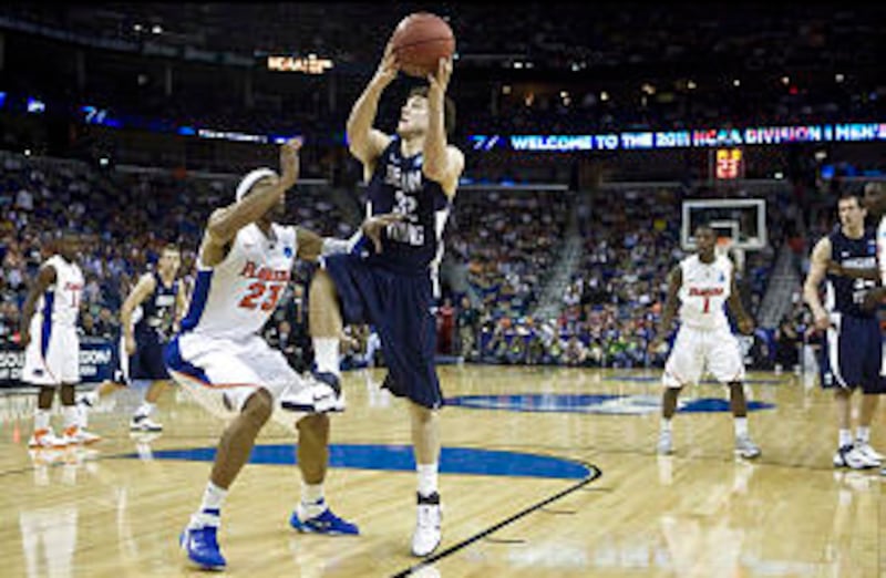 BYU's Jimmer Fredette looks for the basket as he is guarded by Florida's Alex Tyus as the BYU Cougar