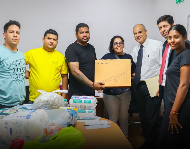 Members of The Church of Jesus Christ of Latter-day Saints pose for a photo as they emergency communication equipment to government officials on July 2, 2026 in La Guaira, Venezuela.
