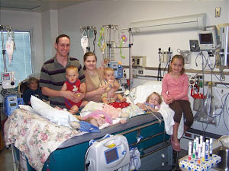 Jake and Erin Herrin, with 1-year-old twins, Austin and Justin, and 6-year-old Courtney, visit daugh