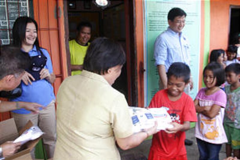 A child happily receives a hygiene kit Volunteers from the LDS Charities of The Church of Jesus Chr