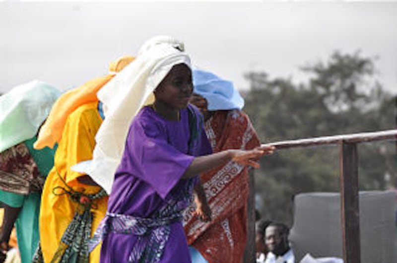 Youth in Accra, Ghana, "reach" for the iron rod.