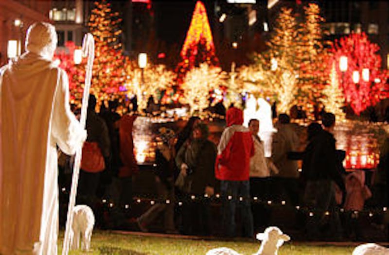 Visitors to Temple Square pass between the reflecting pool and the statues of the shepherds and shee