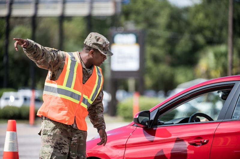 A National Guardsman directs traffic onto U.S. Highway 501 as Hurricane Florence approaches the East Coast Wednesday, Sept. 12, 2018, near Conway, S.C. Time is running short to get out of the way of Hurricane Florence, a monster of a storm that has a region of more than 10 million people in its potentially devastating sights.