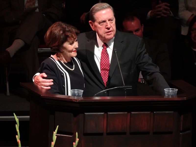 Elder Jeffrey R. Holland and Patricia Holland stand together at the pulpit.