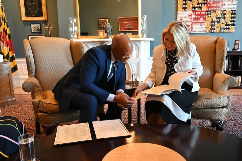 President Camille N. Johnson and Maryland Governor Wes Moore look over his family history in his office in Annapolis, Maryland, on Friday, May 15, 2026.