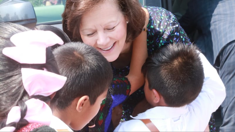 Children hug President Susan H. Porter during her ministry in Chenalhó, Chiapas, Mexico, in May 2026.