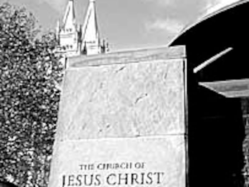 Stone etching of Church's name at the entrance of the Main Street Plaza near Temple Square illustrat