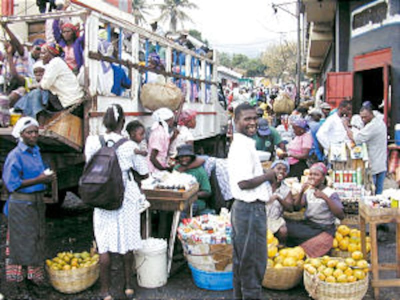 Shoppers and vendors fill the streets of the bustling Petion-Ville Market.