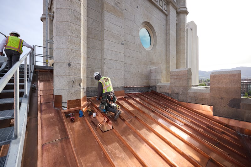 Crews install a new copper roof on the Salt Lake Temple on Tuesday, April 21, 2026, in Salt Lake City.