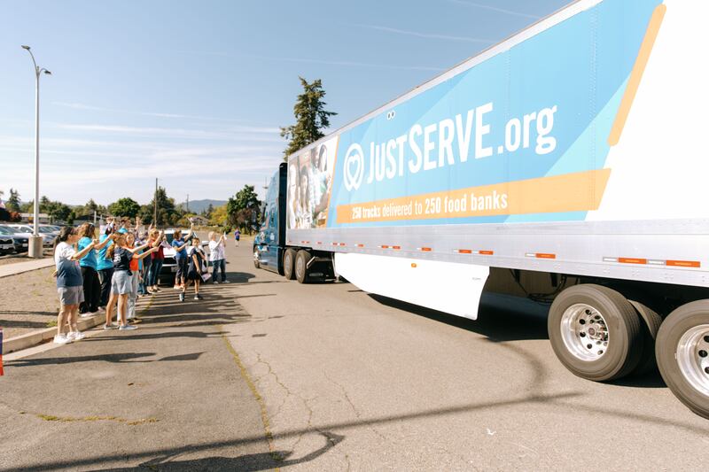 JustServe volunteers celebrate the delivery of a truckload of food from The Church of Jesus Christ of Latter-day Saints to the Partners INW food pantry in Spokane Valley, Washington, on Thursday, June 25, 2026.