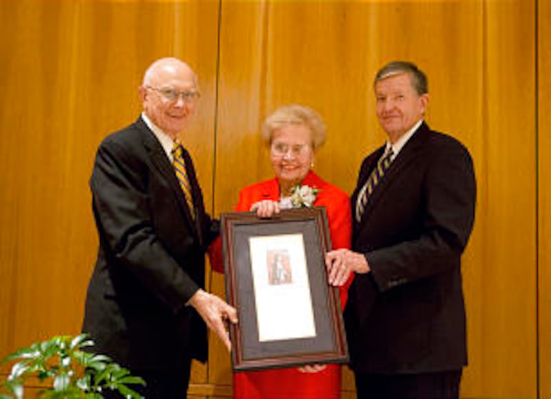 Elder Dallin H. Oaks, left, and BYU President Cecil O. Samuelson honor Daryl Hoole on Nov. 14.