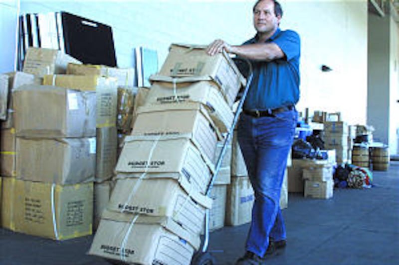 Tim Murdock of Deseret Transportation loads boxes of humanitarian materials sewn by Sea Trek 2001 pa